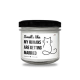 a jar of white candles with a black lid