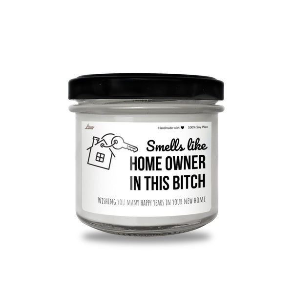 a jar of white candle with a black lid