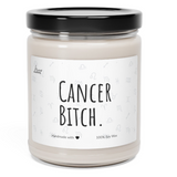 a candle with a black lid that says cancer bitch