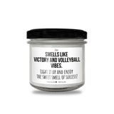 a jar of white candles with a black lid