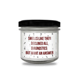 a jar of white candles with red writing on it