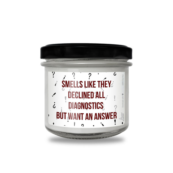 a jar of white candles with red writing on it