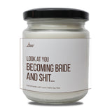 a white jar with a black lid that says look at you becoming bride and shit