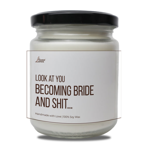 a white jar with a black lid that says look at you becoming bride and shit