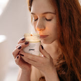 a woman holding a jar of whipped cream