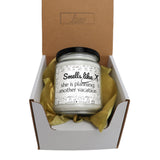 a small jar of candle sitting inside of a box