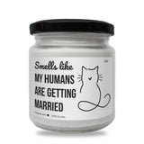 a white jar with a black lid that says smells like my humans are getting married
