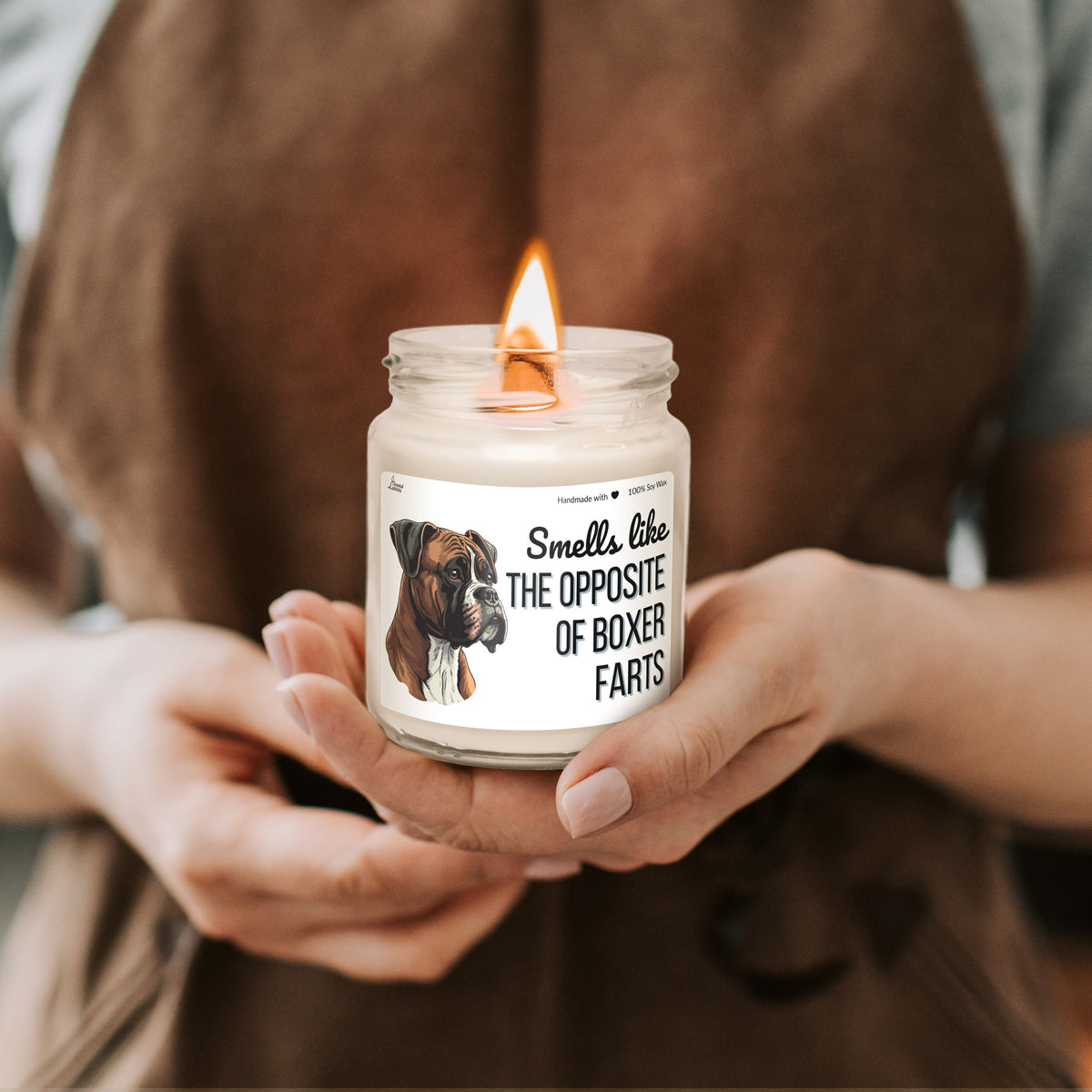 a person holding a candle with a picture of a dog on it