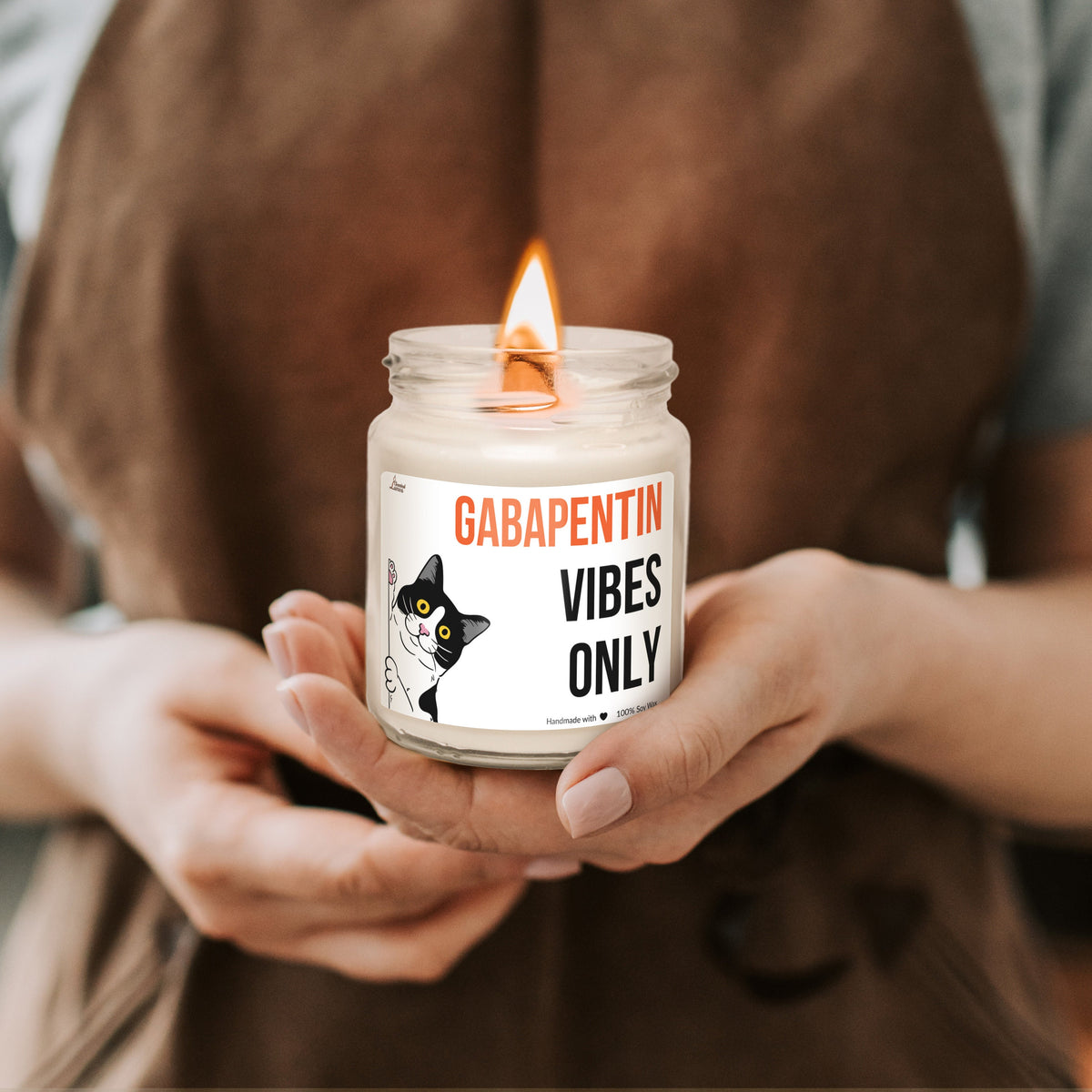 a person holding a jar with a candle in it