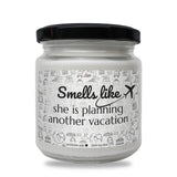 a white jar with a black lid that says smell like x she is planning another