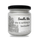 a white jar with a black lid that says smells like she is writing a best