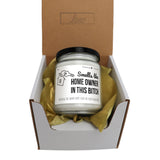 a candle in a gift box with tissue paper