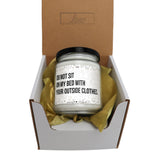 a white jar with a black lid in a box