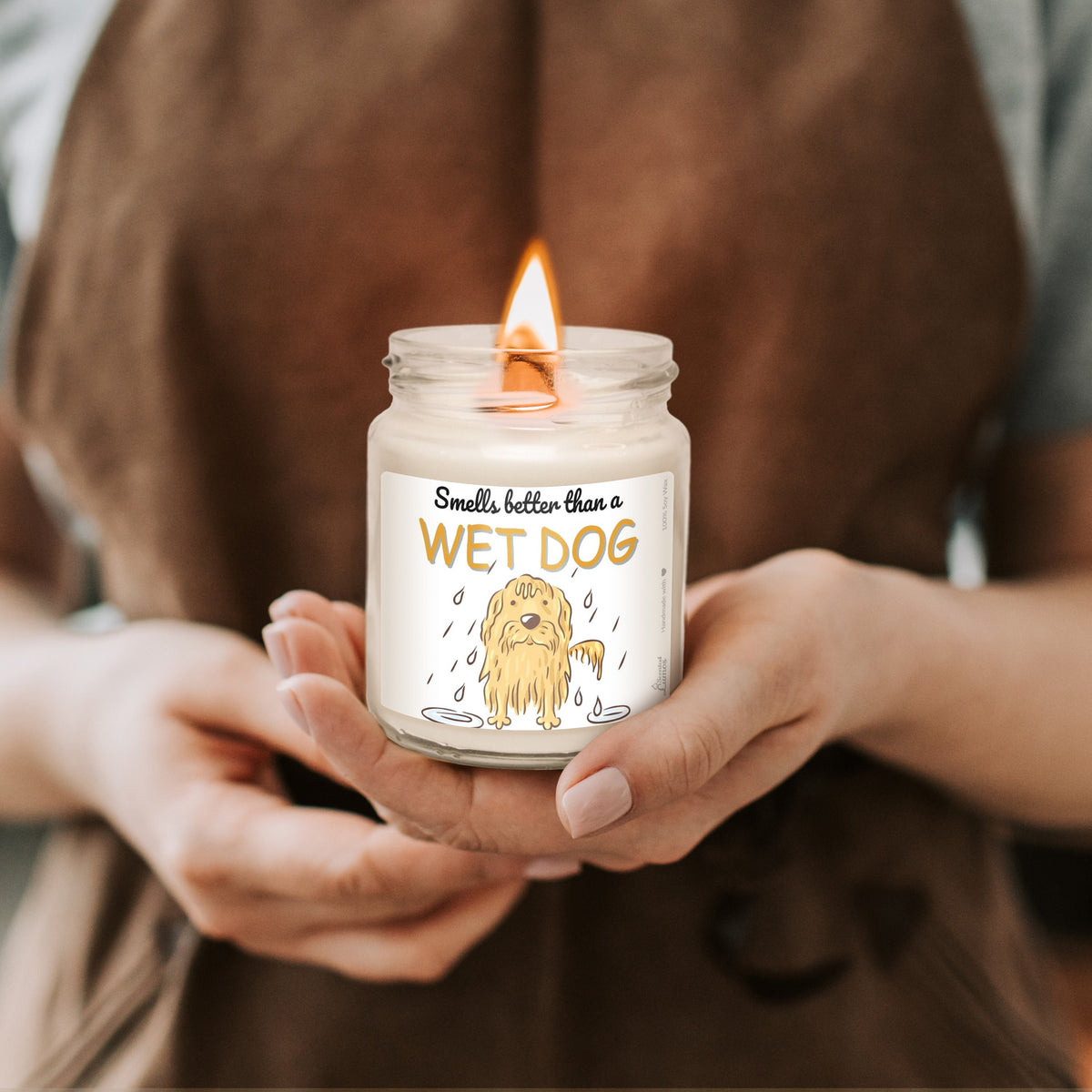 a person holding a candle with a dog on it
