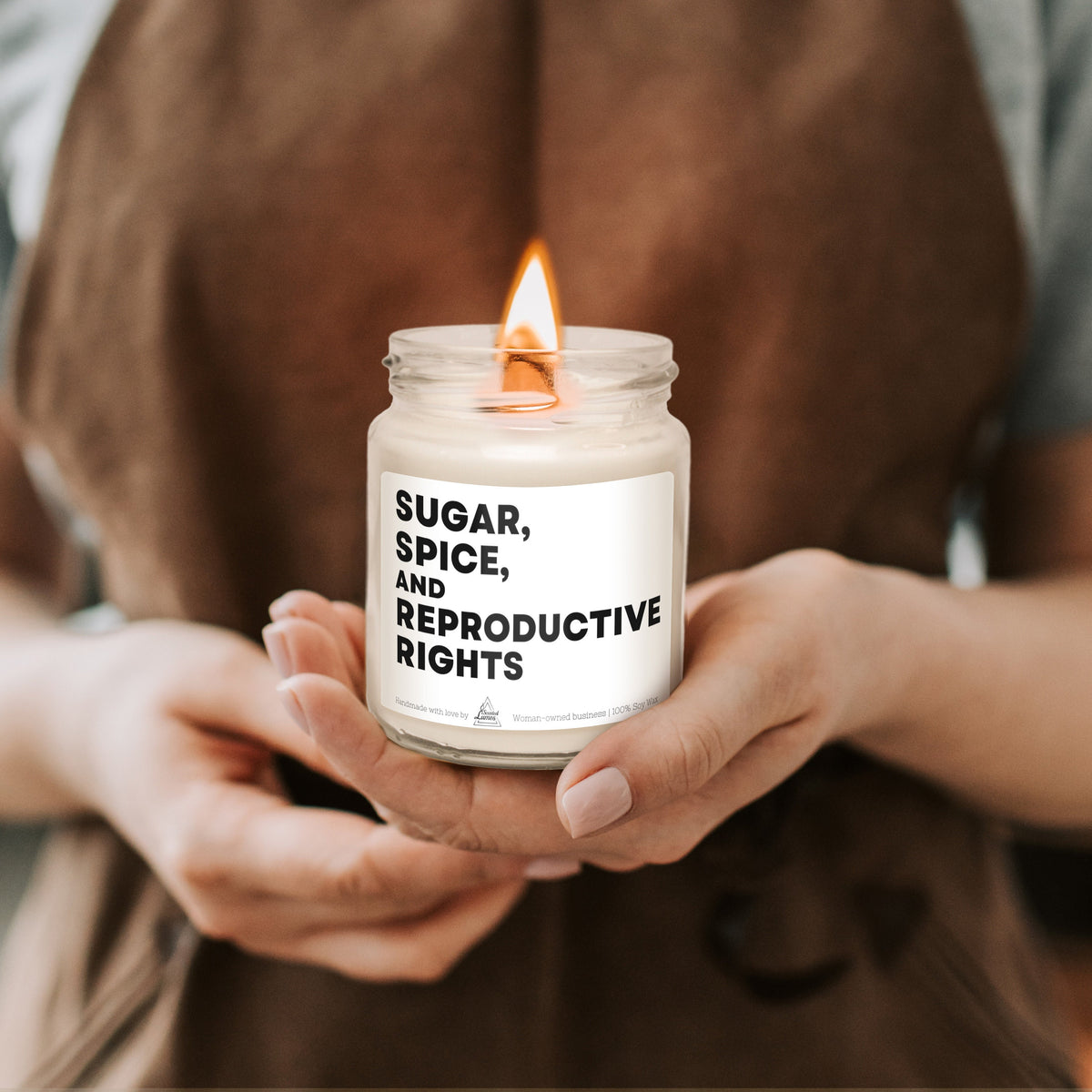 a person holding a jar of sugar, spice, and reproductive lights