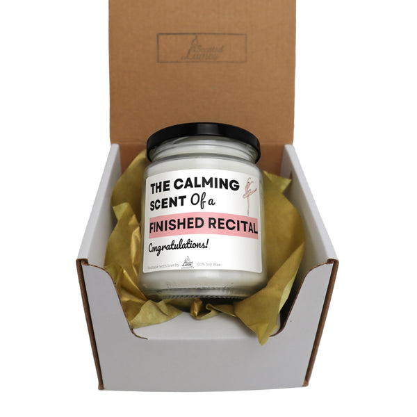 a candle in a gift box with tissue