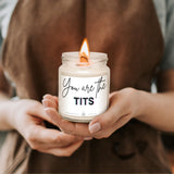 a person holding a jar with a candle in it
