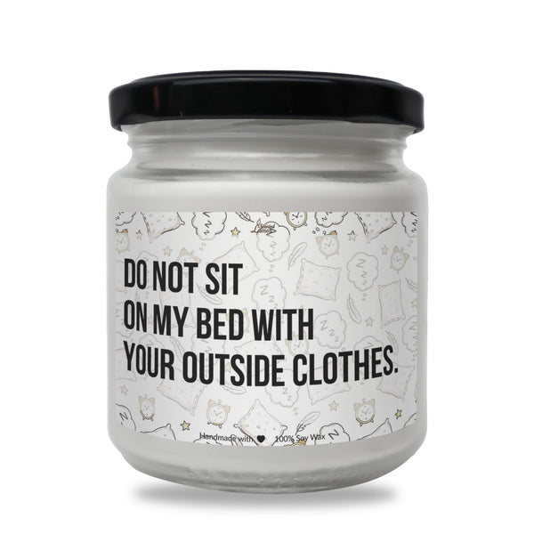 a white jar with a black lid that says do not sit on my bed with