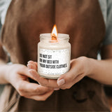 a person holding a jar with a candle in it