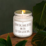 a lit candle sitting on top of a wooden table