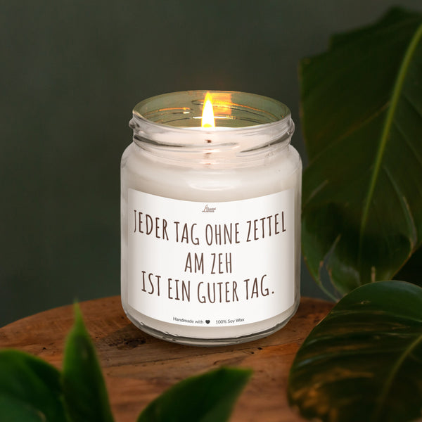 a lit candle sitting on top of a wooden table