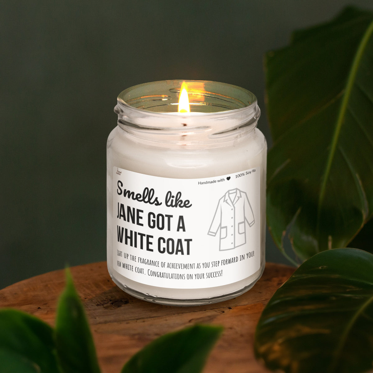 a white candle sitting on top of a wooden table