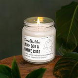 a white candle sitting on top of a wooden table