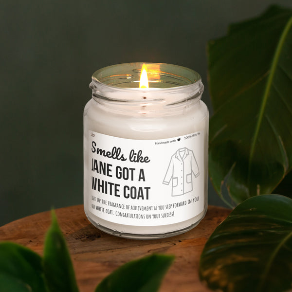 a white candle sitting on top of a wooden table