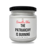 a white jar with a black lid that says smell like the patriachy is