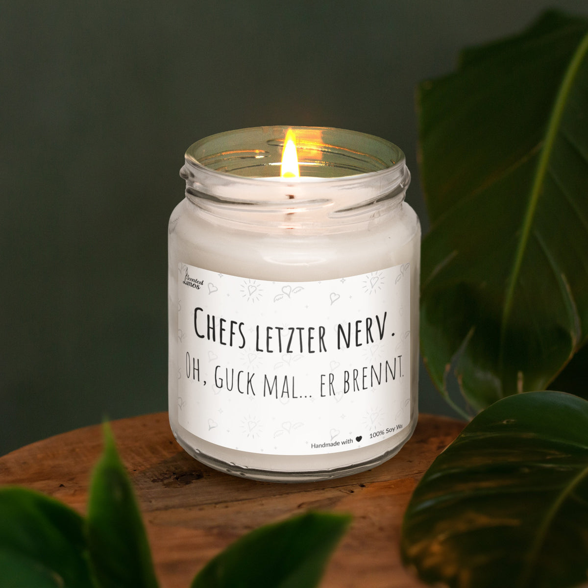 a lit candle sitting on top of a wooden table