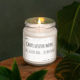 a lit candle sitting on top of a wooden table