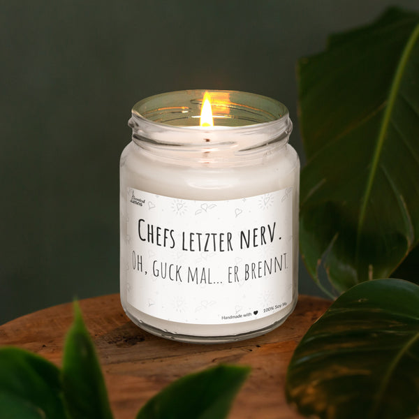 a lit candle sitting on top of a wooden table