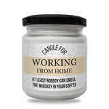 a jar of candle that says working from home at least nobody can smell the whiskey