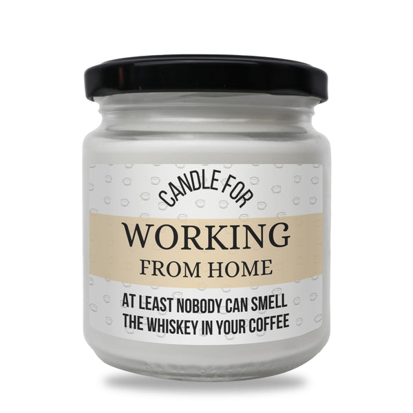 a jar of candle that says working from home at least nobody can smell the whiskey