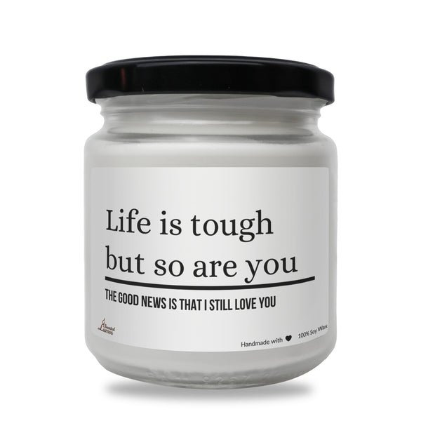 a white jar with a black lid that says life is tough but so are you