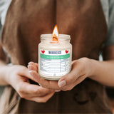 a person holding a jar with a candle in it