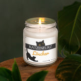 a lit candle sitting on top of a wooden table