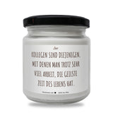 a jar of white candles with a black lid