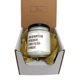 a candle in a box with a brown ribbon around it