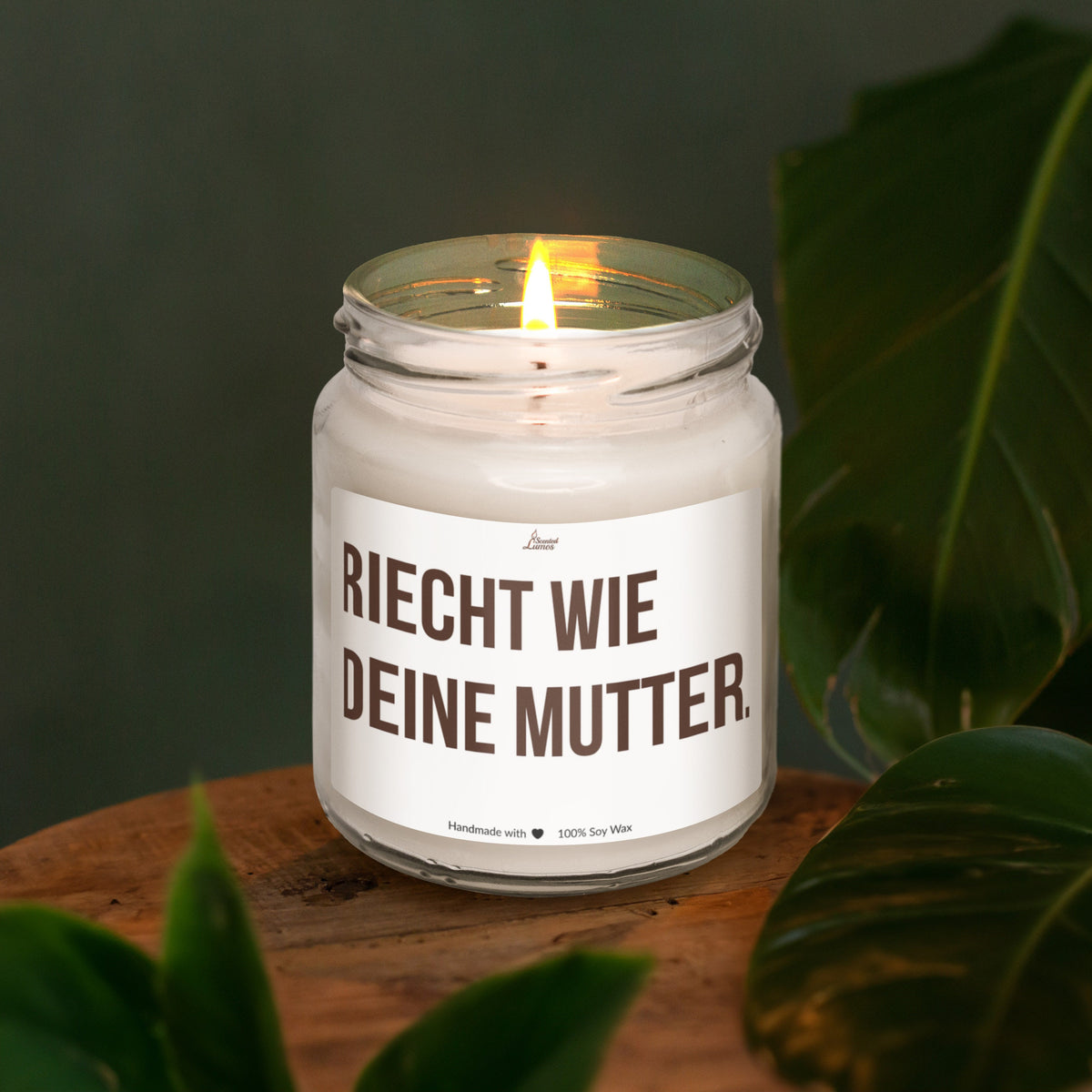 a lit candle sitting on top of a wooden table