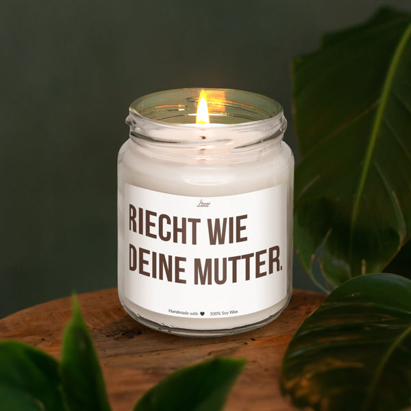 a lit candle sitting on top of a wooden table