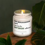 a white candle sitting on top of a wooden table