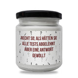 a white jar with a red and black label on it