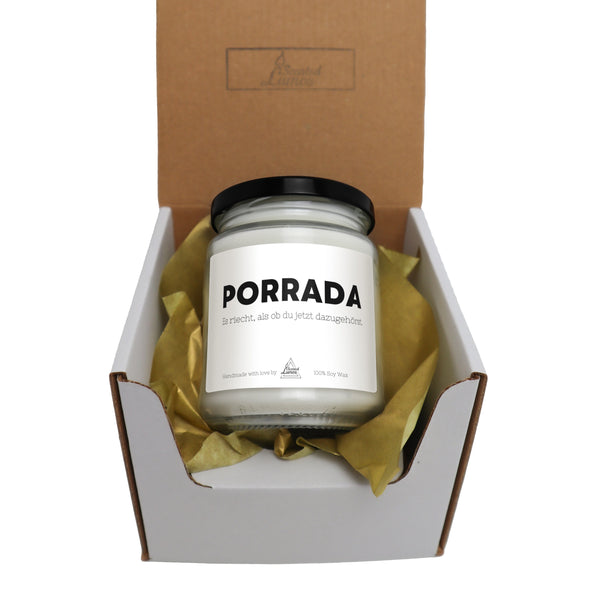 a jar of candle in a box with tissue paper