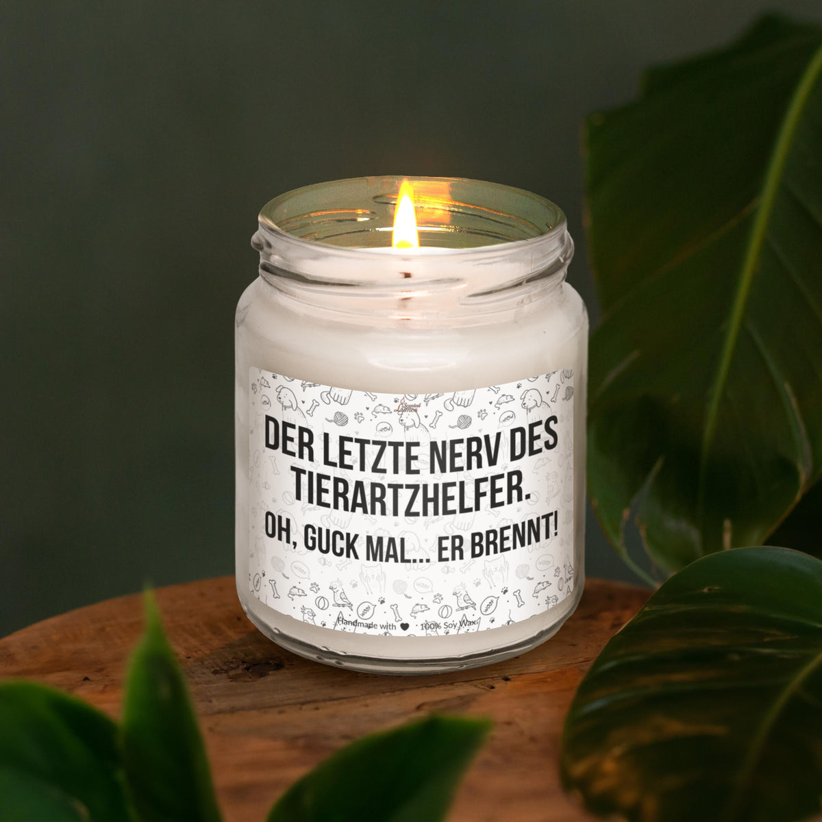 a lit candle sitting on top of a wooden table