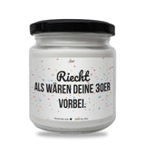 a white jar with a black lid and a black lid