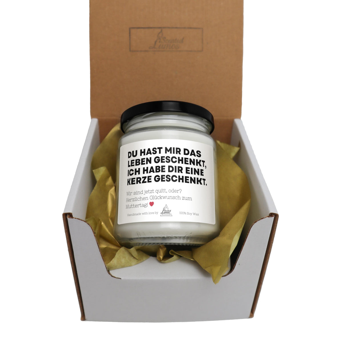 a candle in a box with a yellow ribbon around it