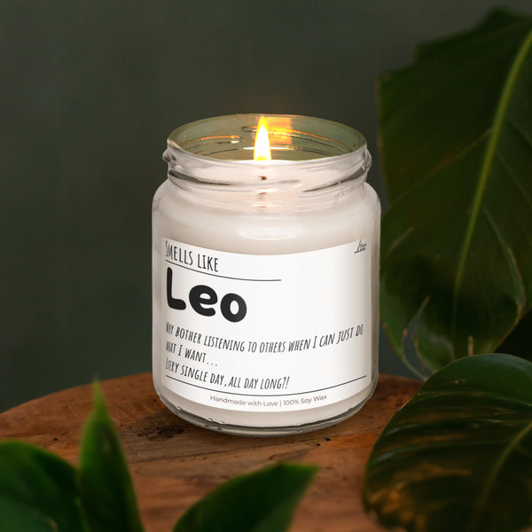 a lit candle sitting on top of a wooden table