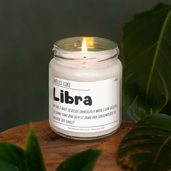 a lit candle sitting on top of a wooden table