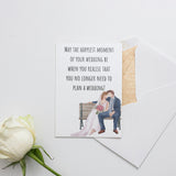 a card with a picture of a bride and groom sitting on a bench